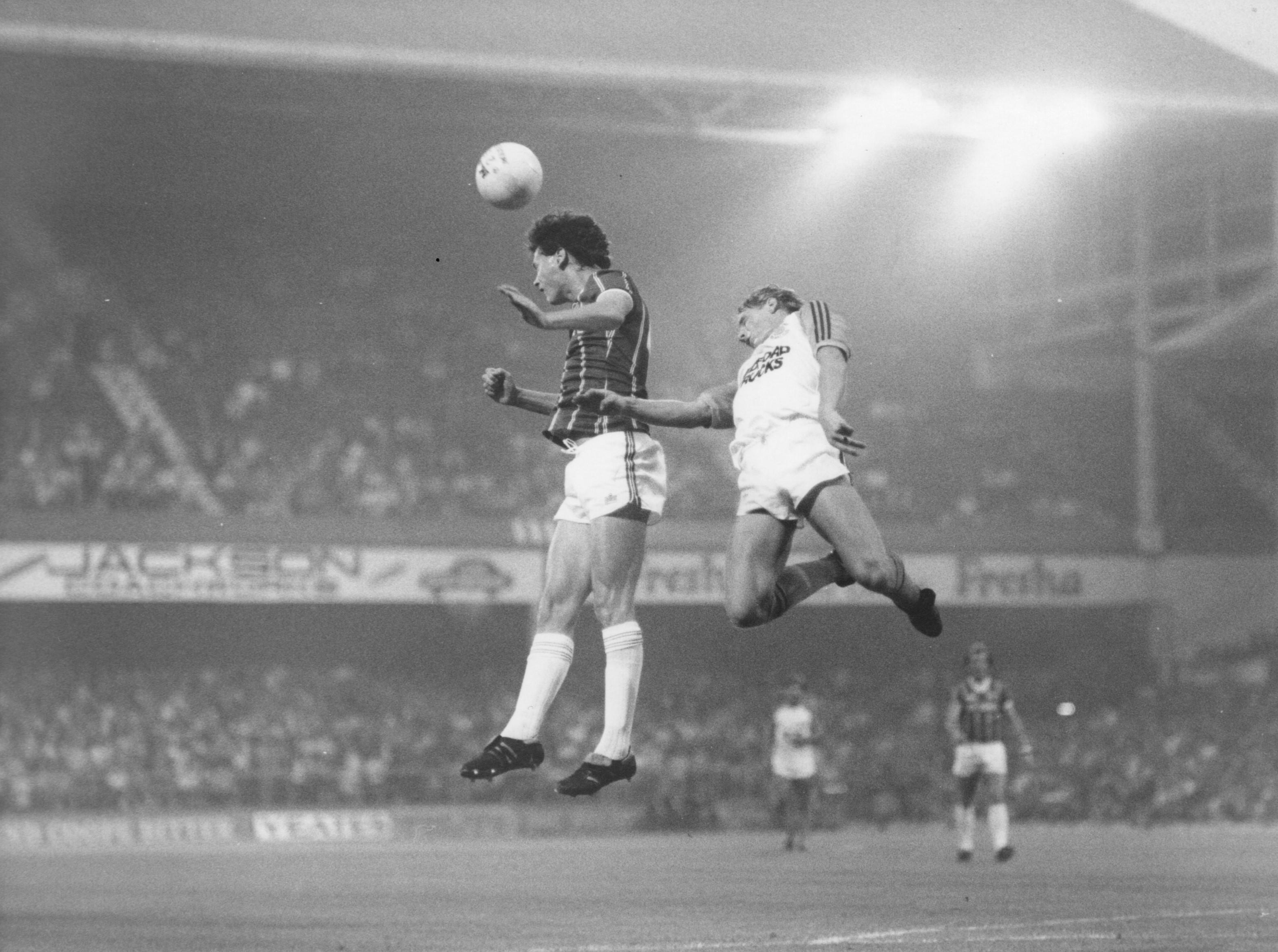 Kevin MacDonald heads the ball away from Paul Walsh