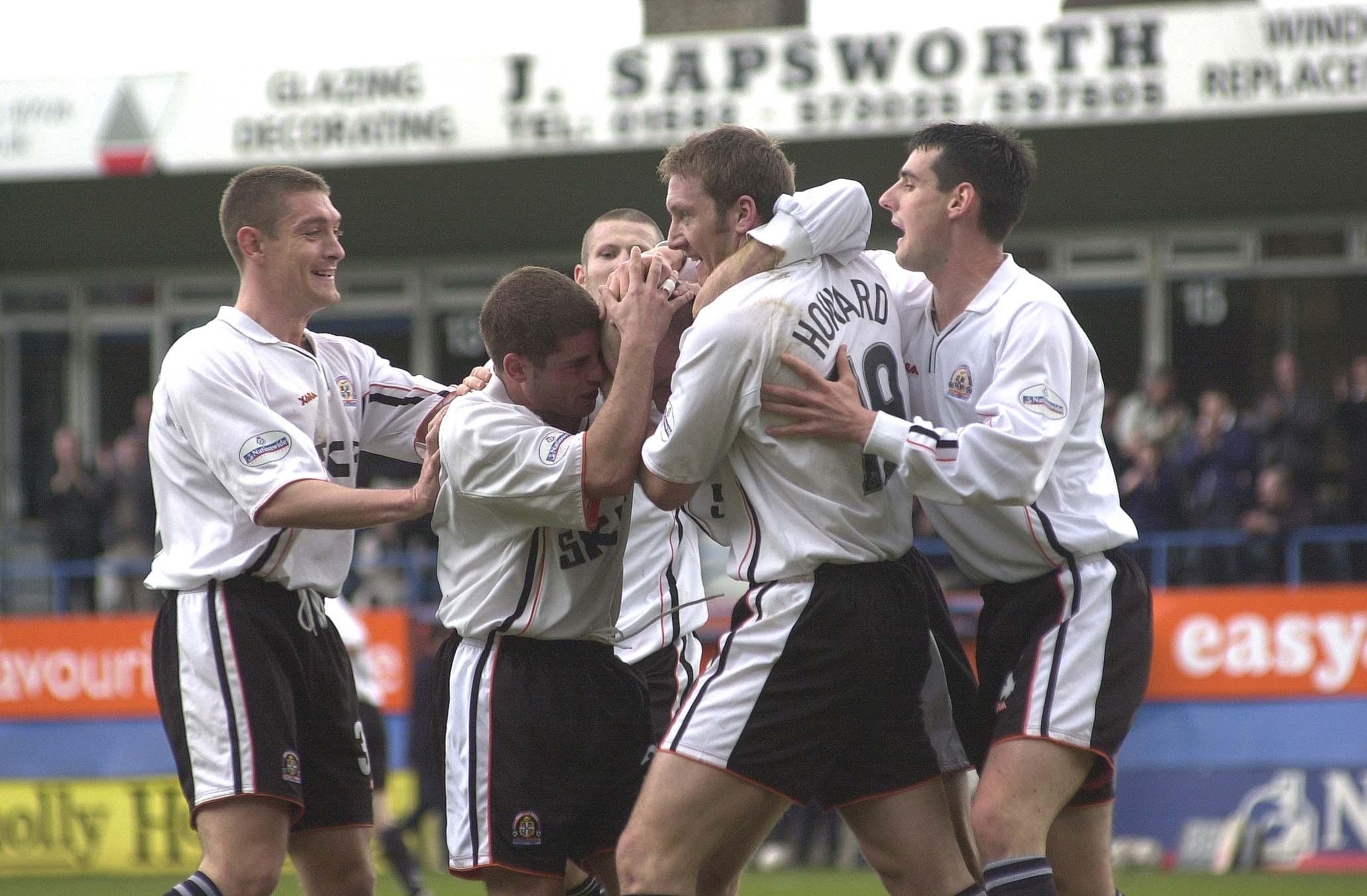 Paul Hughes is mobbed after scoring the only goal of the game